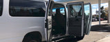 White van with open front doors, showing its interior. A versatile option for **RV rental** or comfortable group travel.