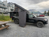 This overland Tacoma rv rental features a rooftop tent & privacy shower, ideal for camping with mountain scenery.