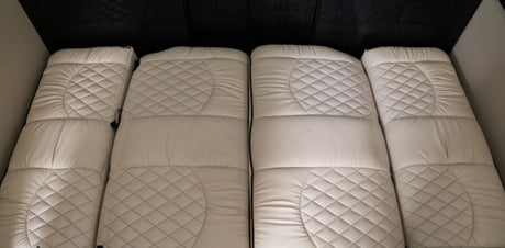 Comfortable, quilted white bedding provides cozy sleeping areas in this RV rental's interior.