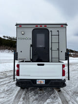 Explore snowy Alaska in this Chevy Silverado rv rental with a gray FISHHOOK truck camper. Ideal for your next outdoor adventure!