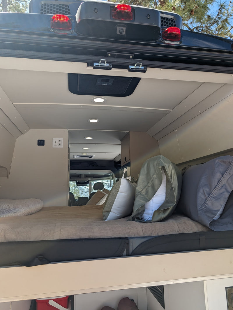  and a window view of snowy pine forest. Ideal for road trips!|Bright and spacious RV rental interior: swiveling seats — photo 14