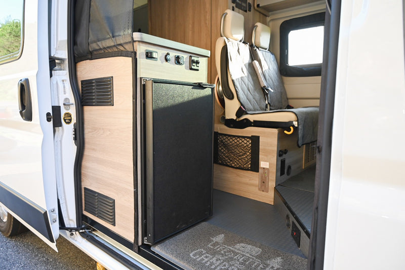  & controls near passenger seats.|Cozy RV rental interior featuring a yellow bed — photo 4