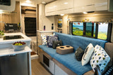 Explore in comfort with this RV rental's spacious interior featuring a kitchen, cozy seating, and scenic window views.