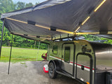 Enjoy an outdoor rv rental adventure! This teardrop travel trailer features an illuminated awning, ideal for cozy camping.