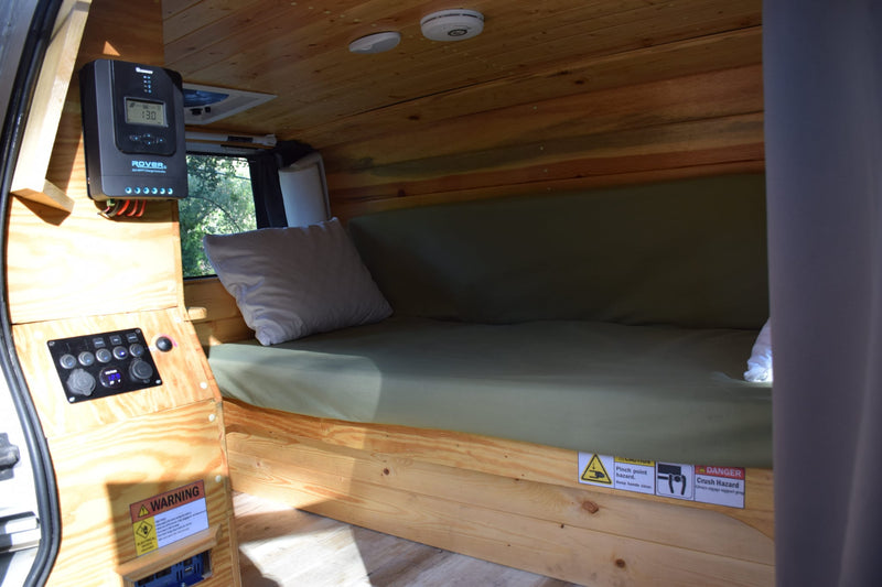  on a scenic winding road through autumn trees. Ideal for road trips and nature.|This white GMC campervan — photo 3