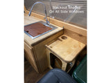 RV rental: wooden galley w/ sink, flexible faucet, & side table w/ cup holder. Blackout shades for privacy.