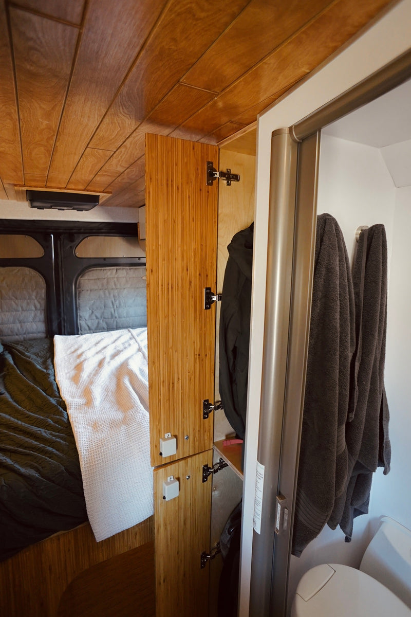  and a compact wet bath with a modern toilet and shower.|View from a cozy RV rental bed — photo 4