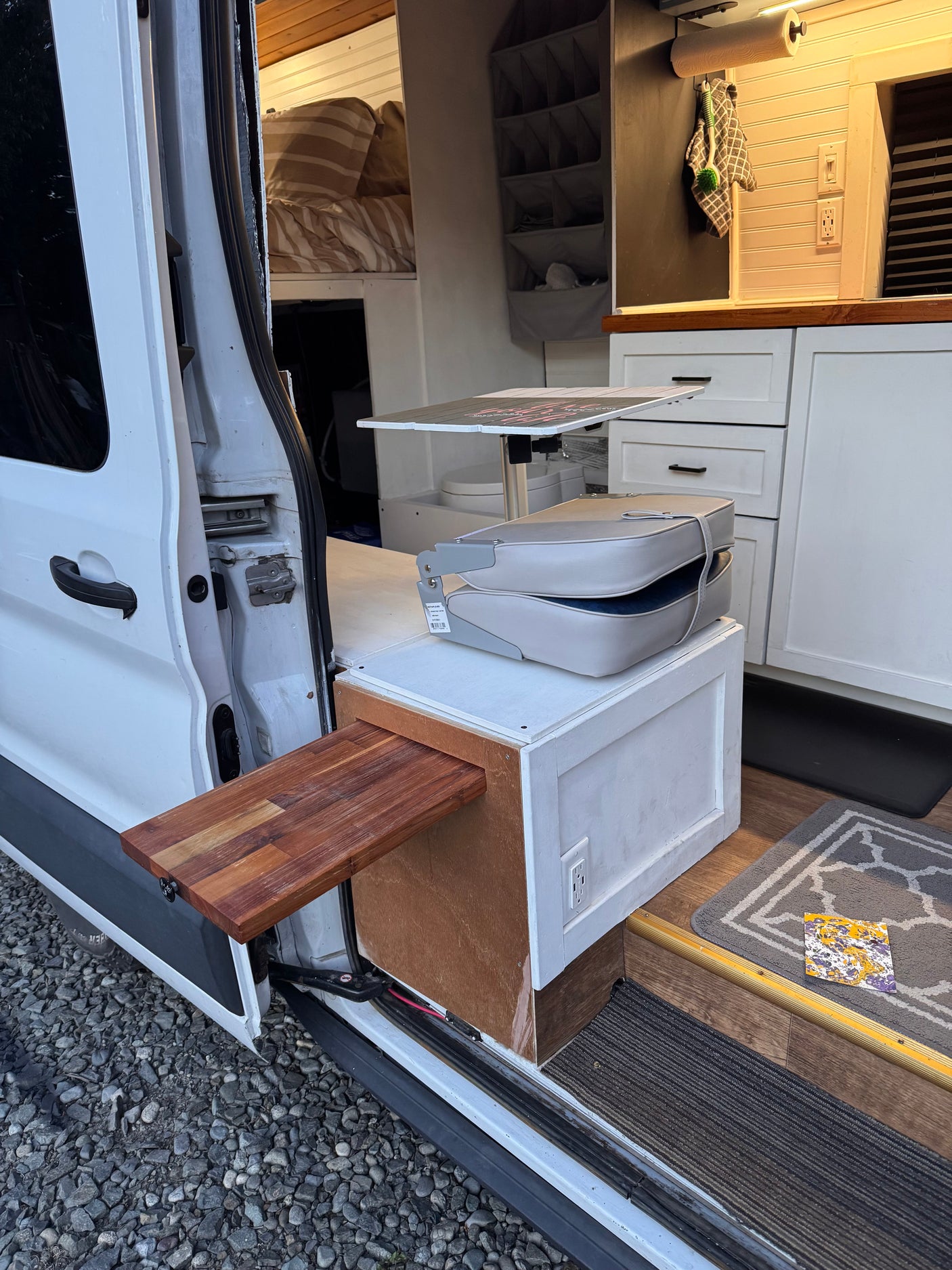 This RV rental shows a practical van interior: compact kitchen, cozy bed, and pull-out table, perfect for mobile living.