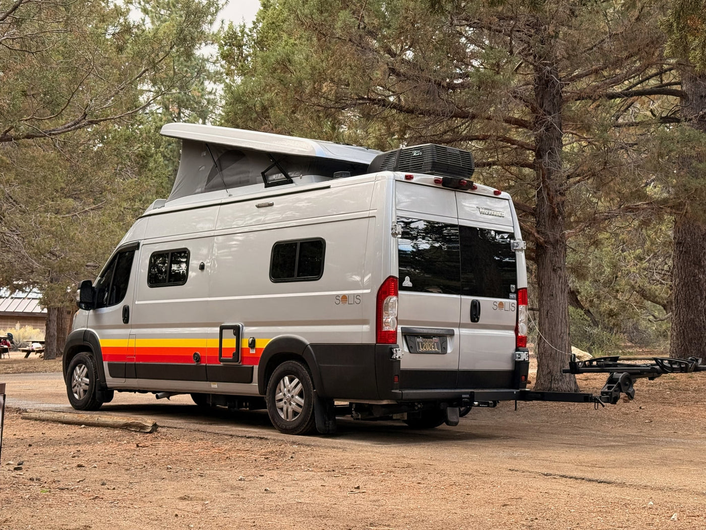  is a perfect RV rental for your next road trip adventure.|Relaxing desert rv rental setup: pop-top camper van with awning — photo 3