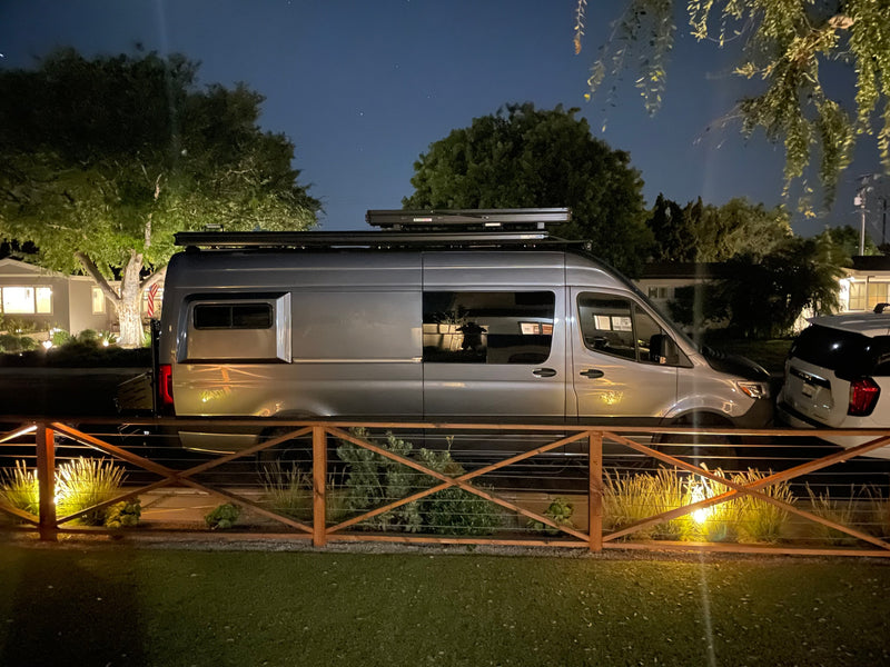  parked on a sunny street.|Experience freedom with this grey camper van — photo 11