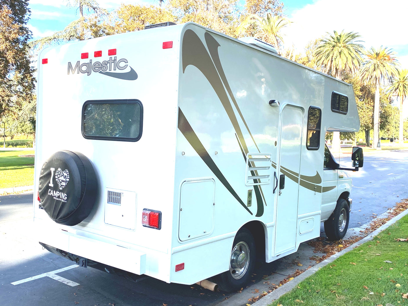 Discover outdoor freedom with this Majestic RV rental! A pristine white Class C camper is seen parked, ready for adventure.