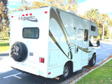 Discover outdoor freedom with this Majestic RV rental! A pristine white Class C camper is seen parked, ready for adventure.