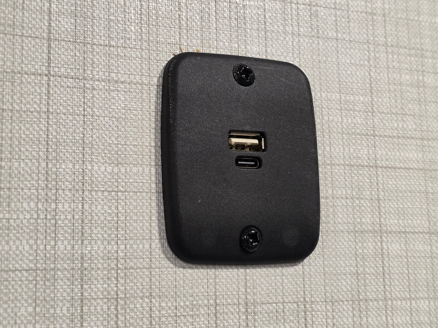 RV rental wall: a black dual USB charging station (Type-A and Type-C) provides convenient power for devices.