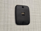 RV rental wall: a black dual USB charging station (Type-A and Type-C) provides convenient power for devices.
