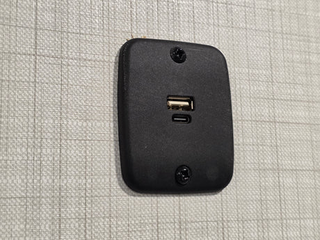 RV rental wall: a black dual USB charging station (Type-A and Type-C) provides convenient power for devices.