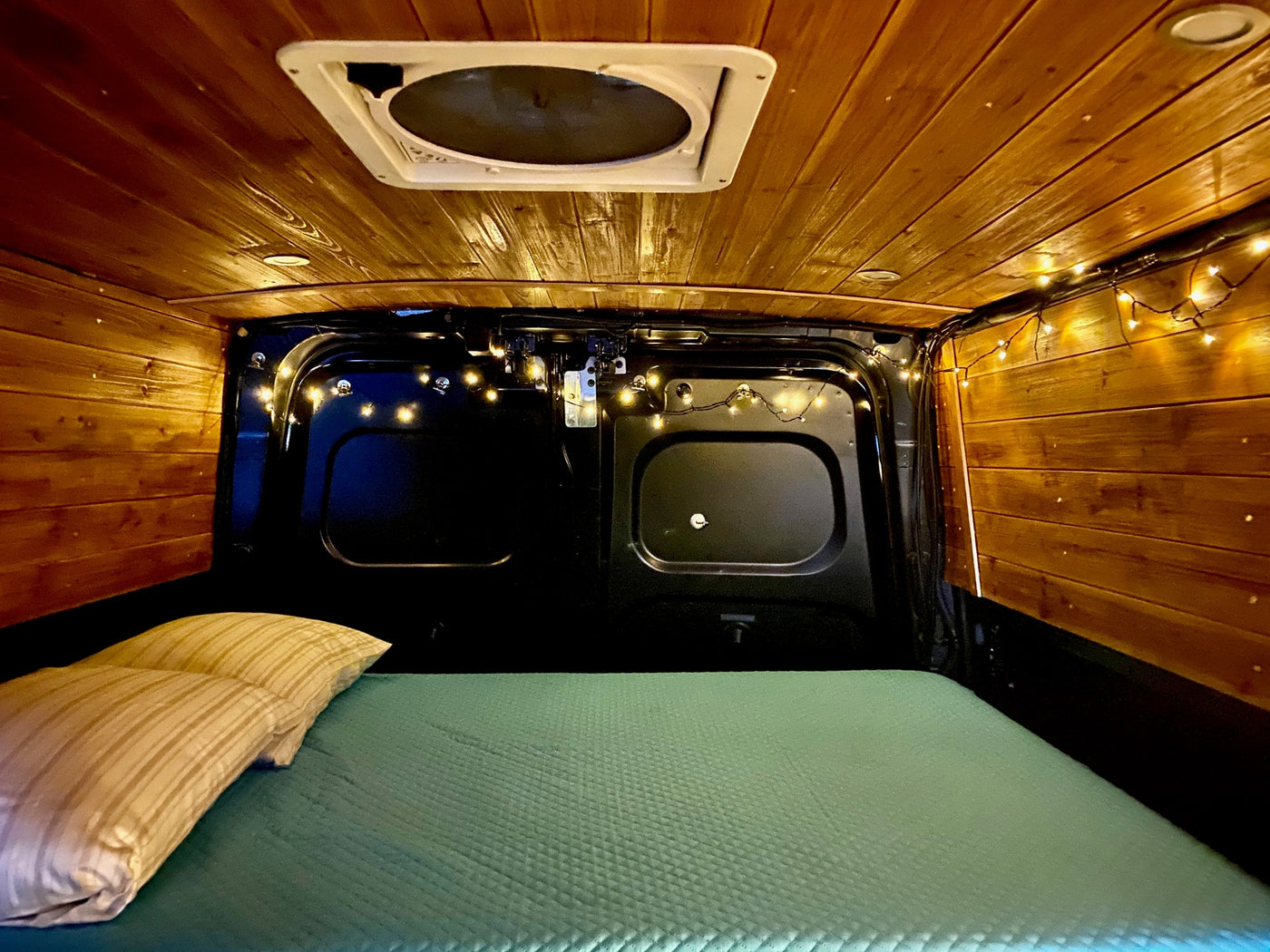  perfect as an rv rental. Its open side reveals a cozy wooden kitchen & storage area.|Inside this RV rental: a cozy — photo 10