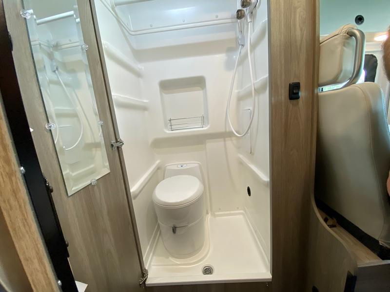  and a scenic lake view through the rear.|Rear view of an rv rental camper van's interior — photo 10