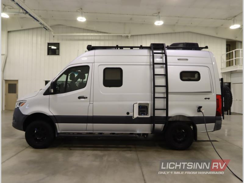  and rear access ladder. View of the van's top.|Rear view of a white Winnebago rv rental. Features include a mounted spare tire — photo 7