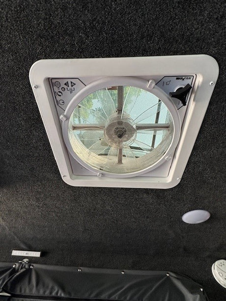 This photo shows a MAX FAN ceiling vent in an RV rental, providing airflow for a comfy journey.