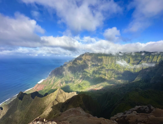 Na Pali Coast, Kauai: Lush green cliffs plunge to blue ocean under cloudy skies. Your RV rental paradise! — photo 9