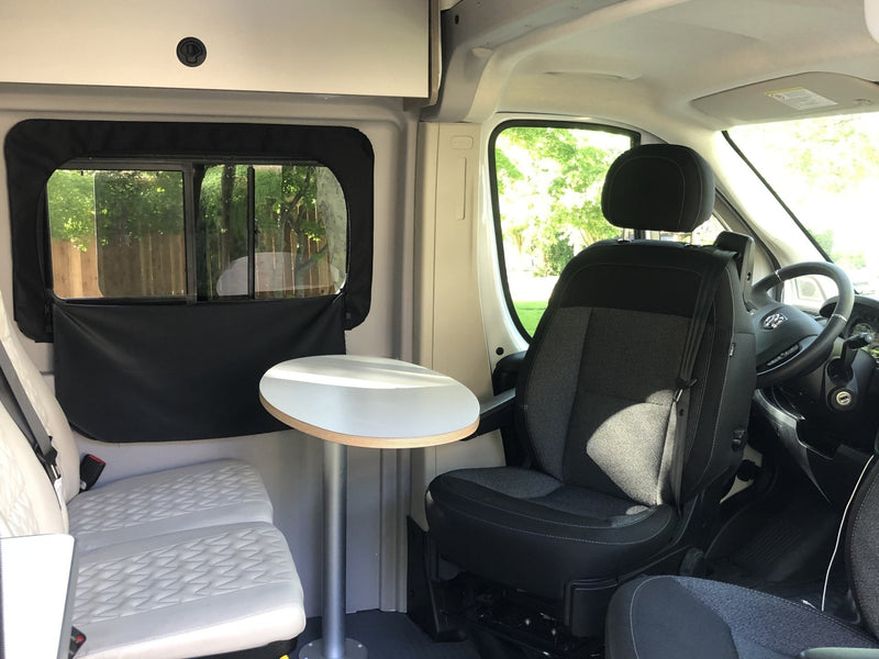  is parked in a scenic grassy area surrounded by trees for a peaceful camping experience.|Inside an RV rental: a compact wet bath featuring a toilet — photo 3