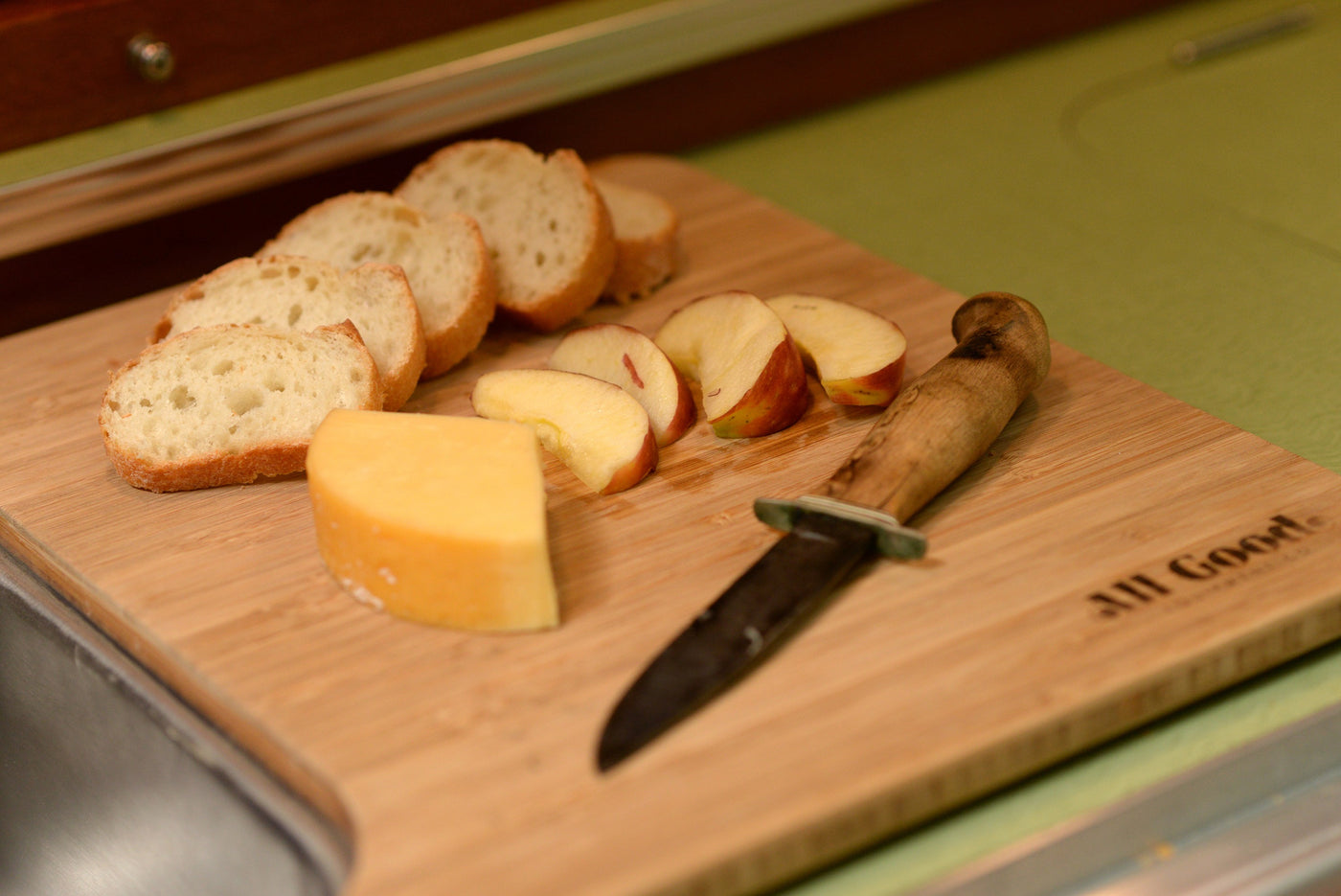Enjoying a light snack of bread slices, cheese, and apples on a cutting board, likely in an RV rental kitchen setup. — photo 8
