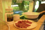 RV rental breakfast: Fresh coffee & crispy bacon on the road. Enjoy simple pleasures while traveling.