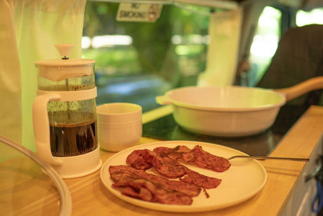 RV rental breakfast: Fresh coffee & crispy bacon on the road. Enjoy simple pleasures while traveling.