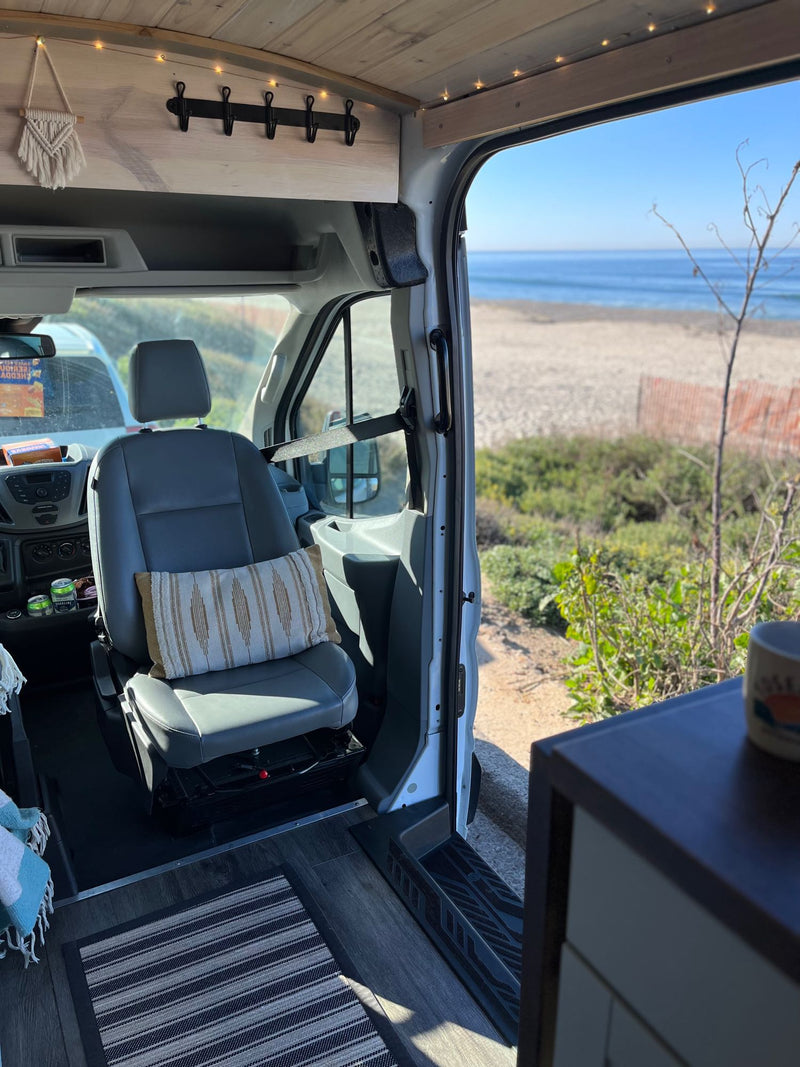 An RV rental's cozy interior, featuring a beach view through the open door, ideal for coastal adventures. — photo 11
