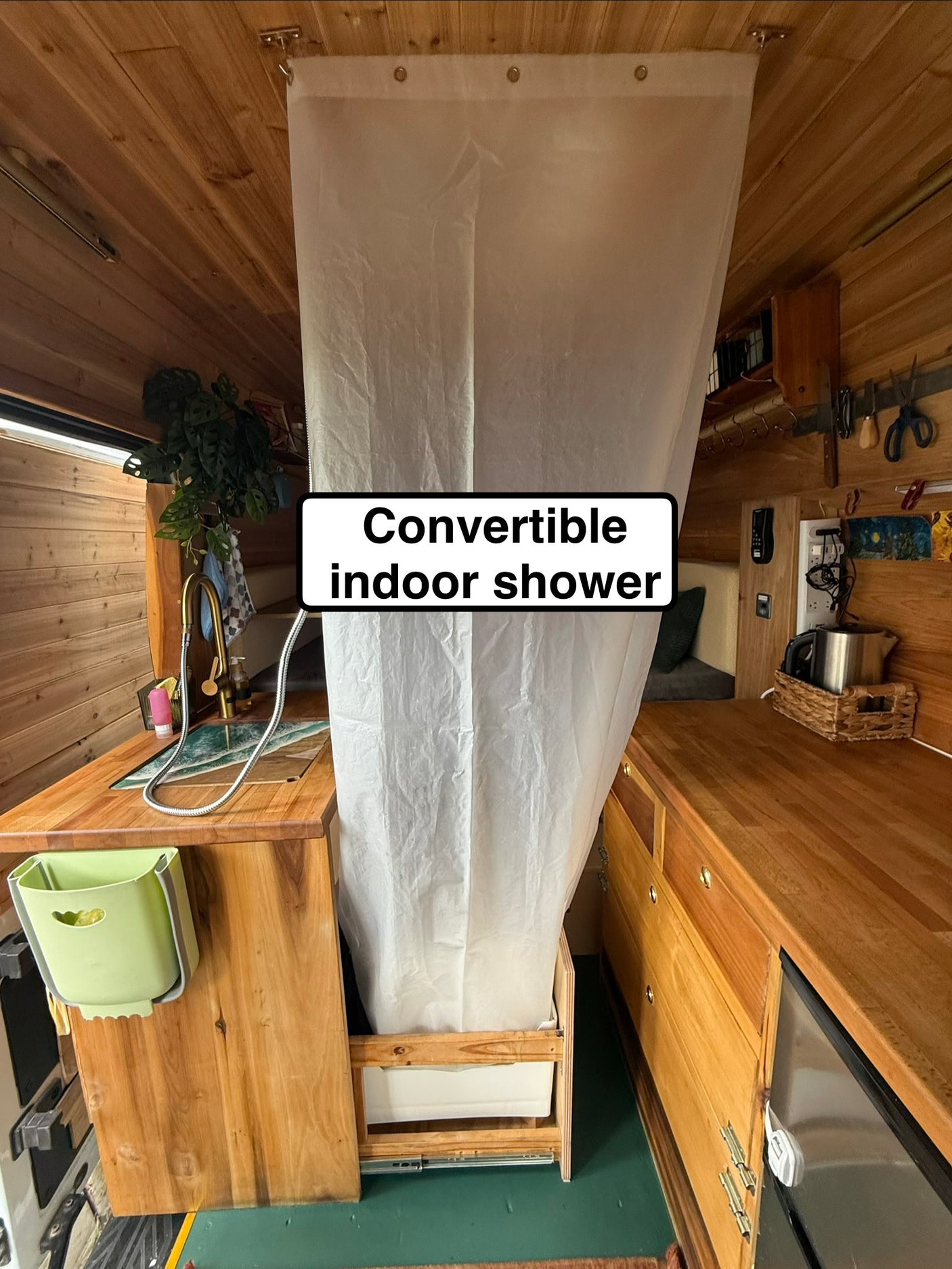 RV rental: Space-saving convertible indoor shower in this wood-paneled camper van setup.