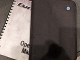 A black VW case and spiral-bound operating manual for an RV rental. Key vehicle info for the journey.