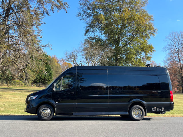 Black Mercedes-Benz Sprinter conversion van parked outside, ideal for luxury RV rental getaways under blue skies.