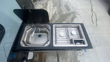 A practical Dometic sink and two-burner stove setup for convenient outdoor cooking in your RV rental.