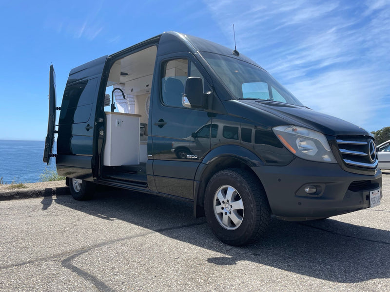 This Mercedes Sprinter camper van, perfect for an RV rental, open to ocean views. Experience van life. — photo 3