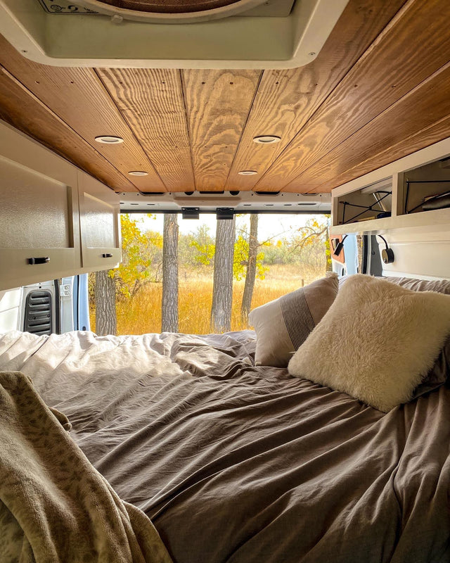  and a scenic autumn view outside.|White RV rental van with its back doors open