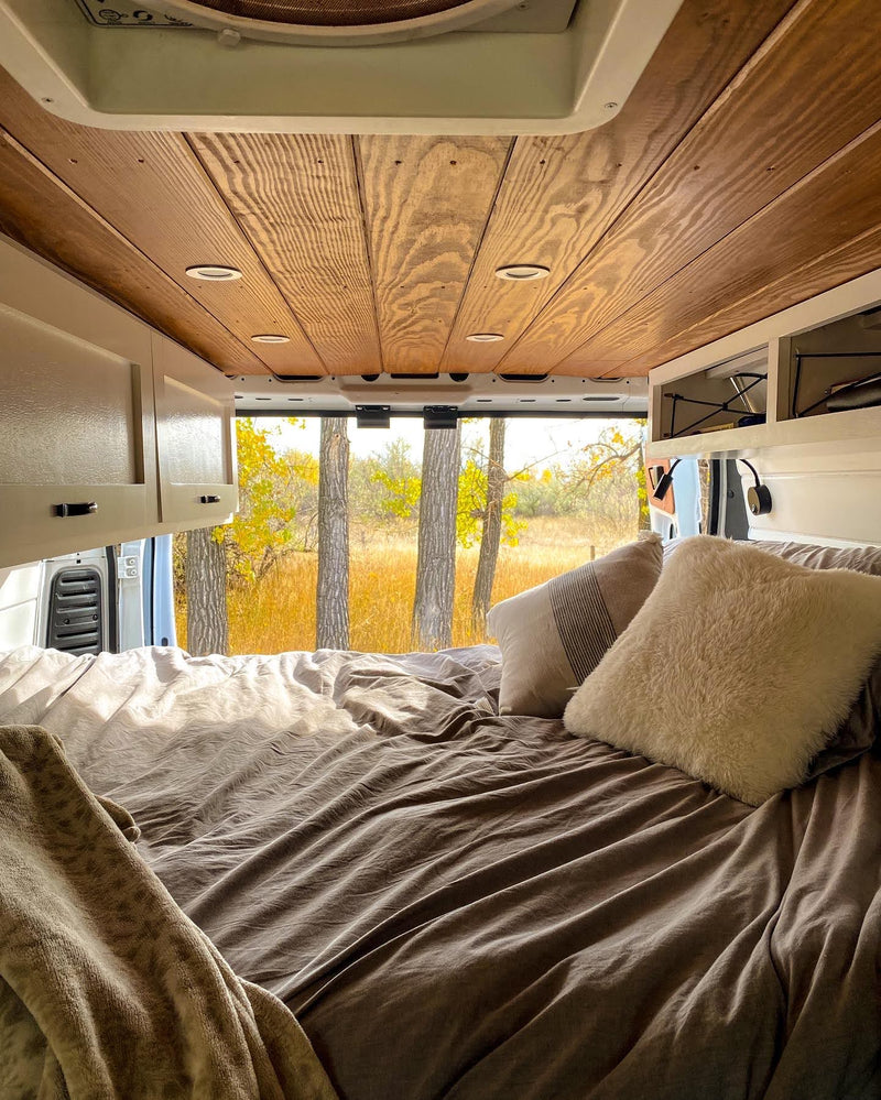  and a scenic autumn view outside.|White RV rental van with its back doors open — photo 1