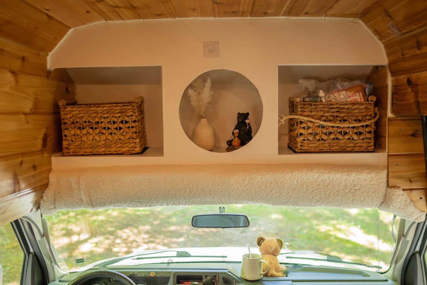  and a compact kitchen area for travelers.|Cozy RV rental interior: wood-paneled living space with kitchen — photo 3