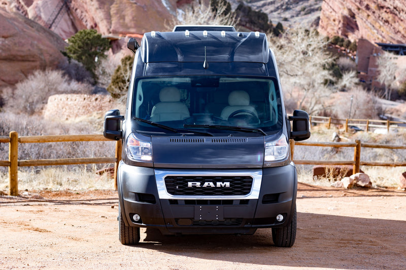  and expandable roof for adventure.|Experience comfort in this RV rental.|A black Ram ProMaster camper van — photo 5