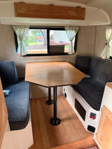  and trailer hitch.|Small cream-colored rv rental travel trailer