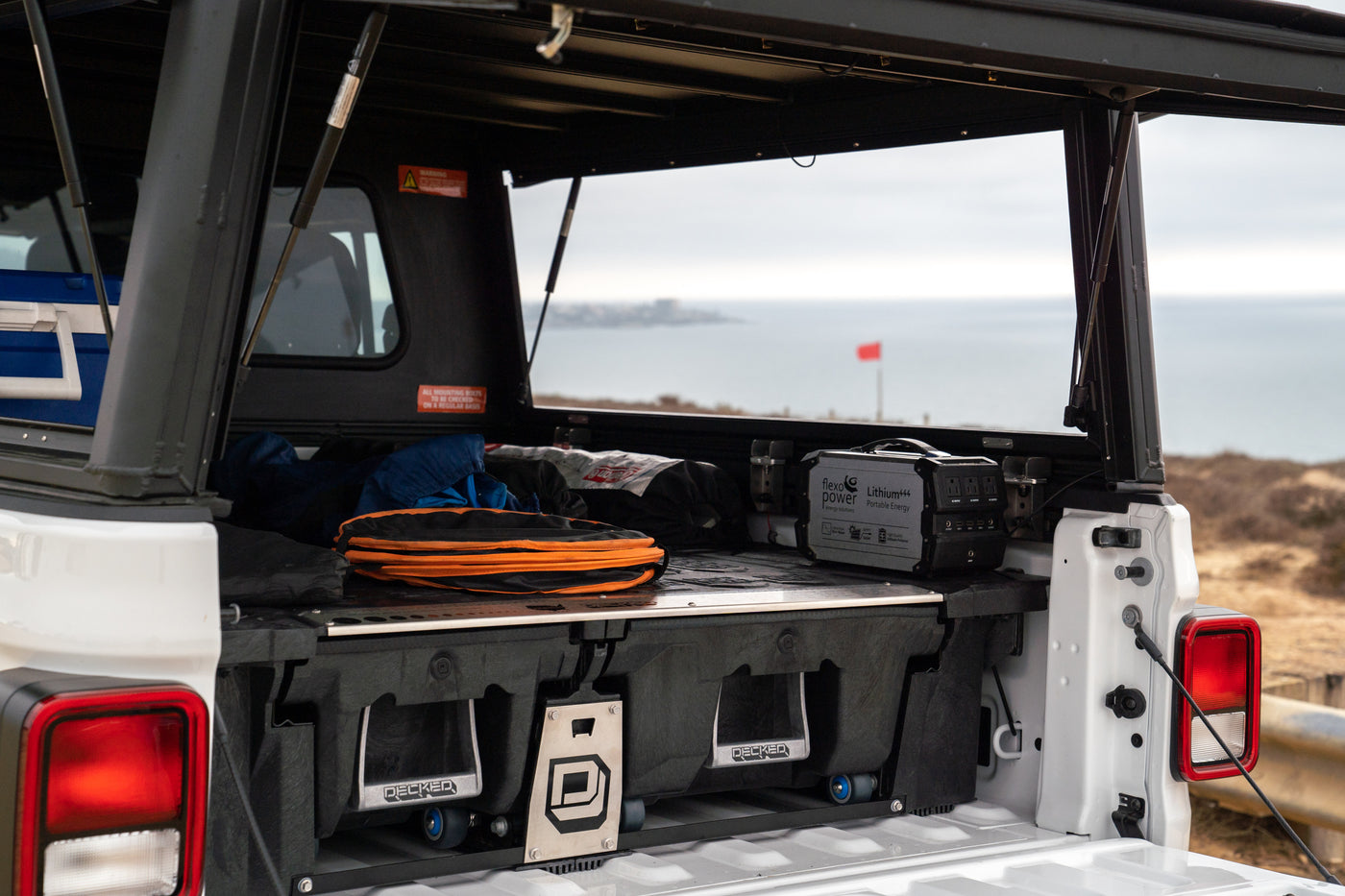 Inside an adventure-ready pickup truck: DECKED storage, FlexoPower portable energy station, and camping gear. Ideal for an RV rental. — photo 9