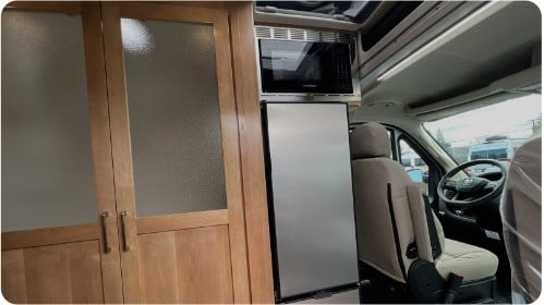  and ample wood storage. A well-equipped mobile home.|RV rental: Inside a camper van with a compact kitchen (sink — photo 9