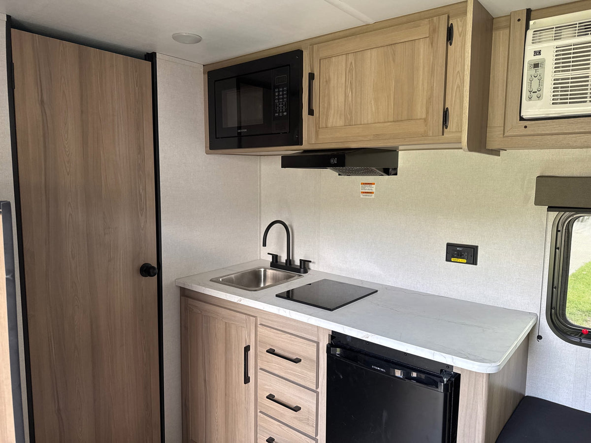 Compact RV rental kitchen with a microwave