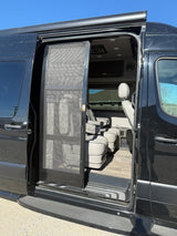 Open side door of a black rv rental van, showing the screen door and plush interior with captain's chairs.