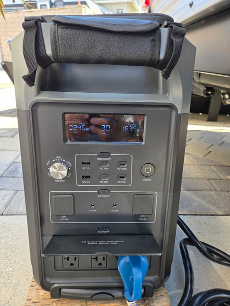 Portable power station charging an RV rental, displaying 30% battery remaining and 1635W output for connected devices.