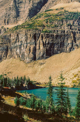Discover this azure mountain lake, framed by majestic cliffs & evergreens. An RV rental trip offers an unforgettable nature escape.