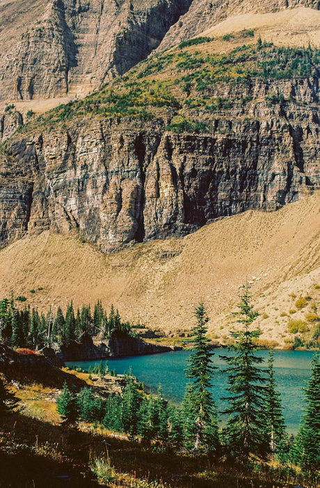 Discover this azure mountain lake, framed by majestic cliffs & evergreens. An RV rental trip offers an unforgettable nature escape.