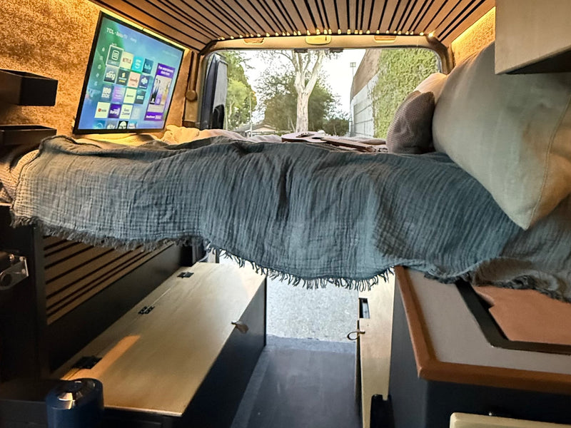  revealing interior and a surfboard outside.|RV rental interior: A modern touchscreen infotainment system and phone mount dominate the Mercedes-Benz dashboard — photo 8