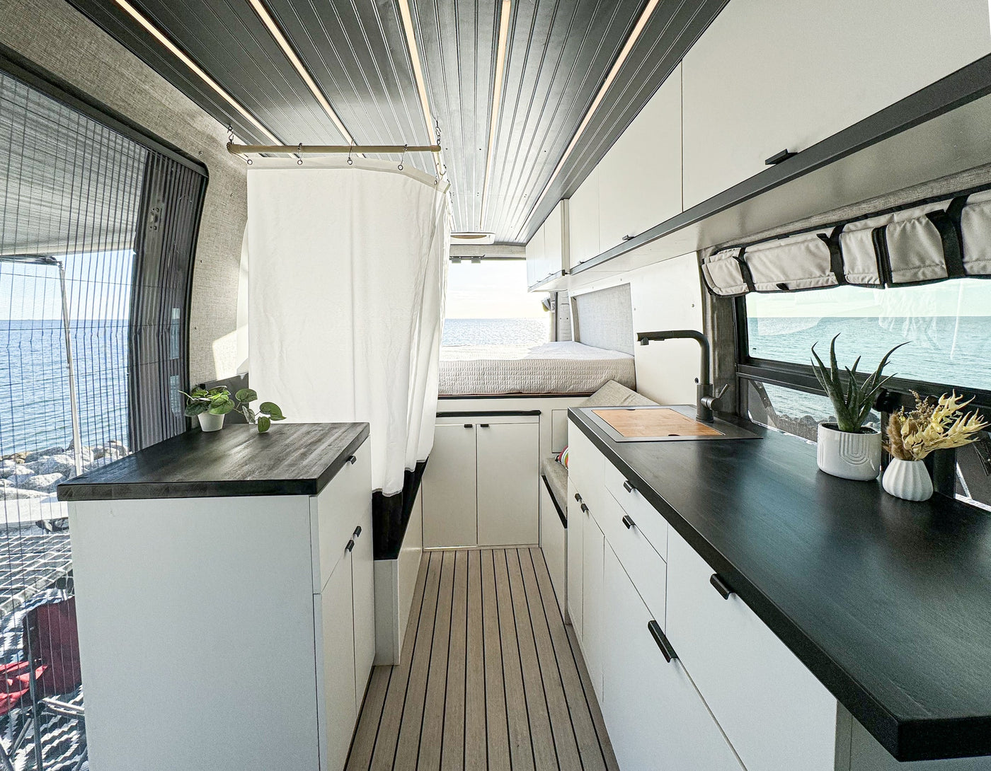  with ocean views. Ideal for your next road trip adventure.|Spacious RV rental interior with a cozy bed — photo 9