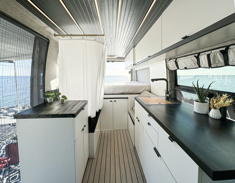  with ocean views. Ideal for your next road trip adventure.|Spacious RV rental interior with a cozy bed — photo 9