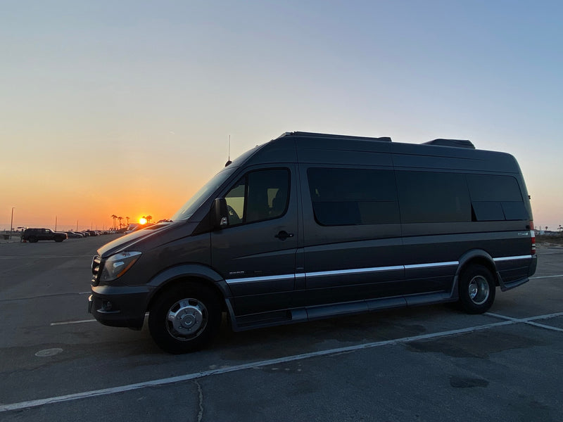  awaits adventure in a parking lot at sunset with palm trees. — photo 13